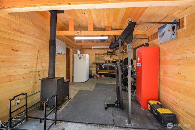 13990 Brae Burn Rd, Leavenworth, WA 98826 - workout room with wood walls and a wood stove