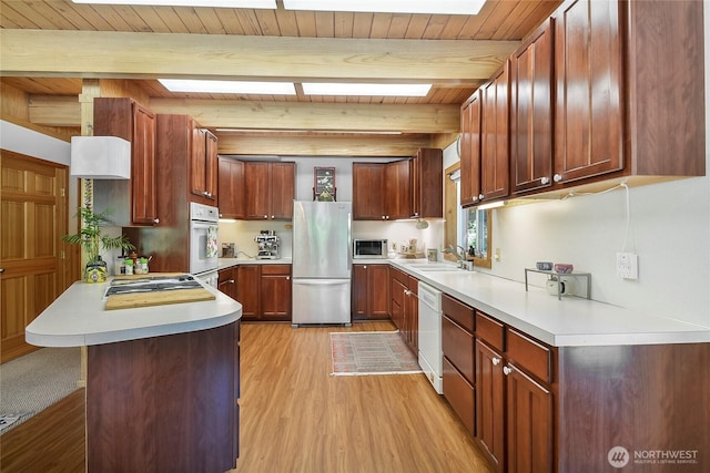 2115 Chiwawa Ct, Leavenworth, WA 98826 - kitchen with stainless steel appliances, a peninsula, light wood-style floors, a wood ceiling with exposed beams, and light countertops