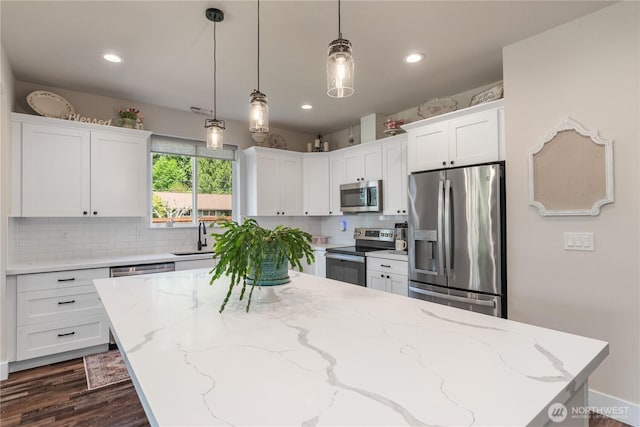 10 Coyote Rd, Montesano, WA 98563 - kitchen featuring stainless steel appliances, white cabinetry, backsplash, a center island, and pendant lighting