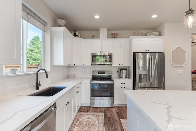 10 Coyote Rd, Montesano, WA 98563 - kitchen with stainless steel appliances, white cabinets, dark wood-style floors, tasteful backsplash, and recessed lighting