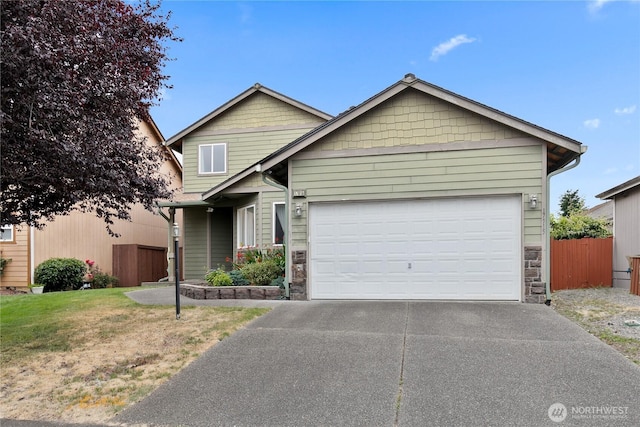 17915 25th Ave E, Tacoma, WA 98445 - view of front of property featuring driveway, stone siding, and an attached garage