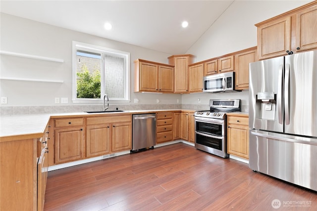 17915 25th Ave E, Tacoma, WA 98445 - kitchen featuring stainless steel appliances, open shelves, light countertops, dark wood-style flooring, and lofted ceiling
