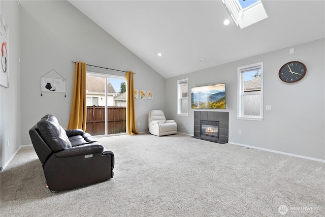 17915 25th Ave E, Tacoma, WA 98445 - living room with a tile fireplace, carpet floors, a skylight, plenty of natural light, and high vaulted ceiling