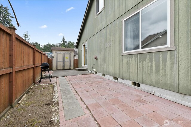 17915 25th Ave E, Tacoma, WA 98445 - fenced backyard featuring a storage shed, a patio, and a grill
