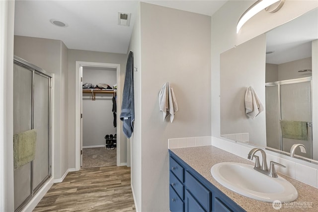 11389 Thompson Rd NE, Moses Lake, WA 98837 - bathroom featuring vanity, a walk in closet, and a shower stall