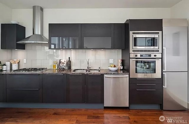 737 Olive Way Unit 3110, Seattle, WA 98101 - kitchen featuring appliances with stainless steel finishes, wall chimney range hood, modern cabinets, and dark stone countertops