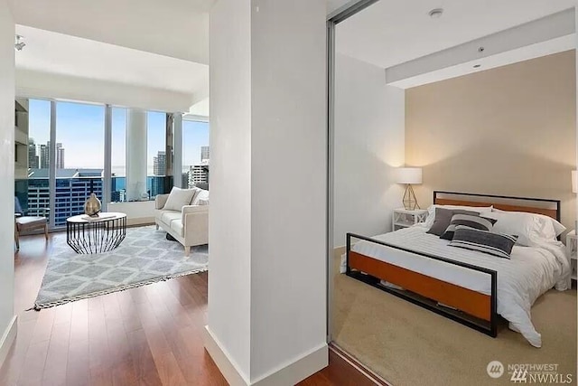 737 Olive Way Unit 3110, Seattle, WA 98101 - bedroom featuring wood finished floors and a city view