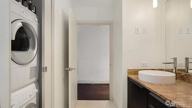 737 Olive Way Unit 3110, Seattle, WA 98101 - laundry room with stacked washing machine and dryer and baseboards