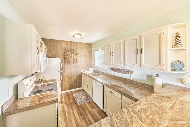 210 26th St NW Unit 428, Long Beach, WA 98631 - kitchen featuring white appliances, tile countertops, wood finished floors, and wood walls