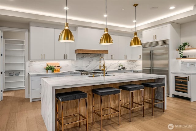 4719 86th Ave SE, Mercer Island, WA 98040 - kitchen with beverage cooler, built in fridge, tasteful backsplash, light wood-style floors, and recessed lighting