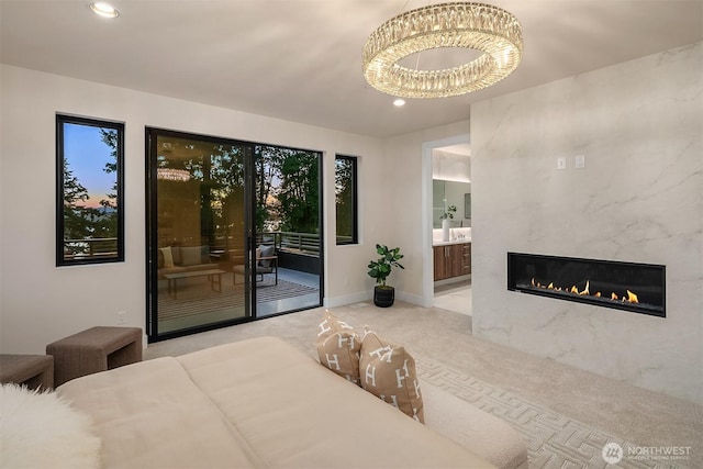 4719 86th Ave SE, Mercer Island, WA 98040 - carpeted bedroom featuring access to outside, a chandelier, recessed lighting, ensuite bath, and a premium fireplace