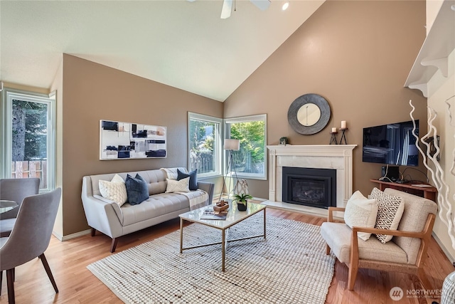 31451 48th Pl SW, Federal Way, WA 98023 - living area featuring a glass covered fireplace, light wood-style floors, high vaulted ceiling, and a ceiling fan