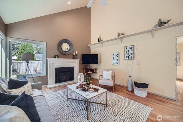 31451 48th Pl SW, Federal Way, WA 98023 - living room with high vaulted ceiling, light wood-type flooring, a fireplace with raised hearth, and ceiling fan