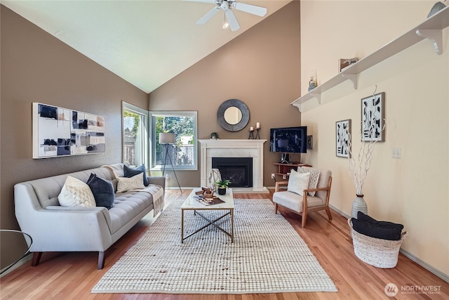 31451 48th Pl SW, Federal Way, WA 98023 - living area with high vaulted ceiling, wood finished floors, a fireplace with raised hearth, and ceiling fan