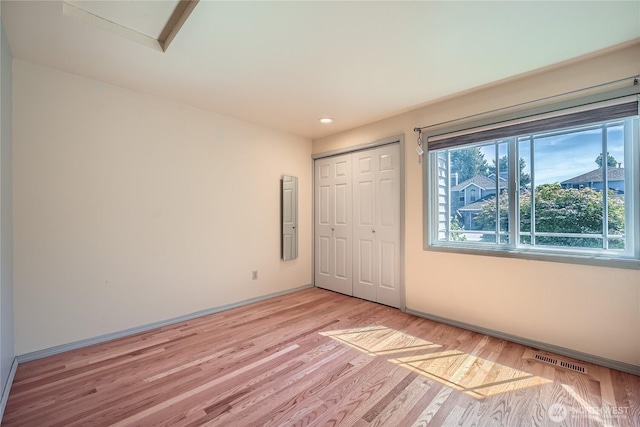 31451 48th Pl SW, Federal Way, WA 98023 - unfurnished bedroom with light wood-type flooring, a closet, and recessed lighting