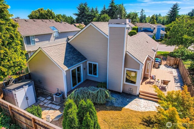 31451 48th Pl SW, Federal Way, WA 98023 - rear view of house with a wooden deck, a fenced backyard, roof with shingles, and a chimney