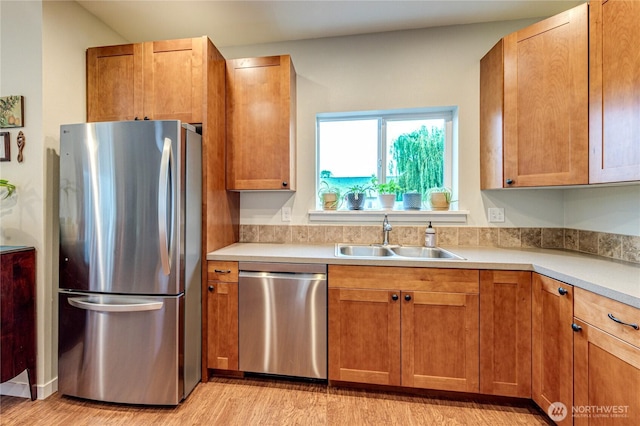 31 Nimbus Ln, Sequim, WA 98382 - kitchen with stainless steel appliances, light wood-style floors, light countertops, and brown cabinets