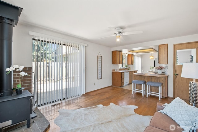 2528 S 363rd St, Federal Way, WA 98003 - living area with a wood stove, ceiling fan, and wood finished floors