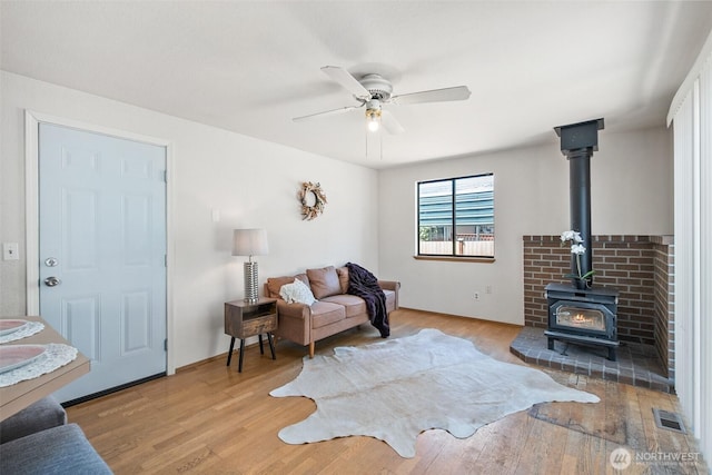 2528 S 363rd St, Federal Way, WA 98003 - living area featuring a wood stove, wood finished floors, and a ceiling fan