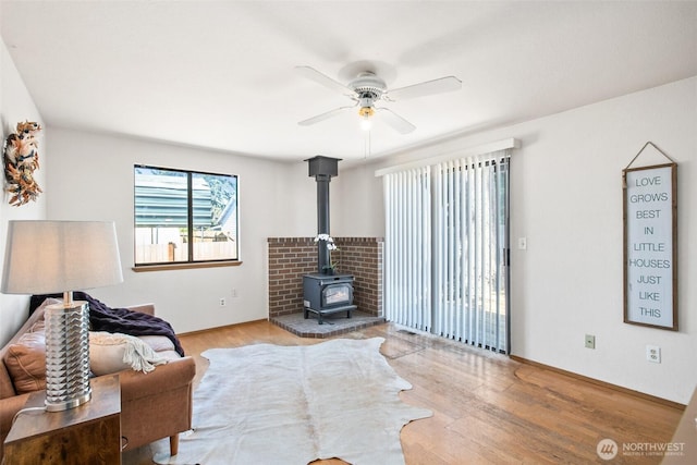 2528 S 363rd St, Federal Way, WA 98003 - living room with ceiling fan, a wood stove, and wood finished floors