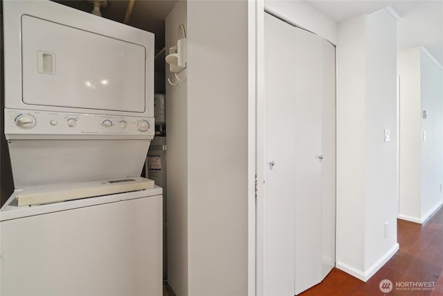 121 Vine St Unit 402, Seattle, WA 98121 - laundry room featuring estacked washer and dryer and dark wood-style floors