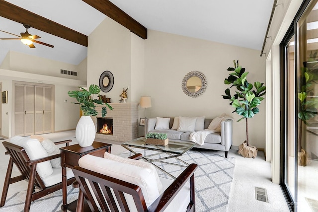 1541 NE 143rd St Unit H5, Seattle, WA 98125 - living area featuring a fireplace, a ceiling fan, beam ceiling, carpet, and high vaulted ceiling