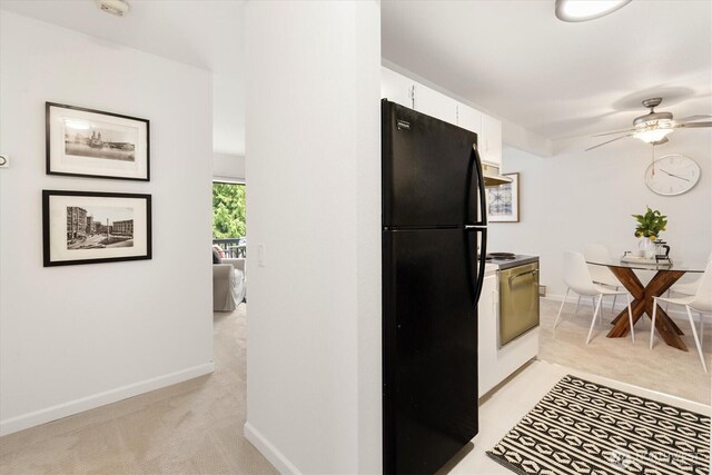 19411 56th Ave W Unit 321, Lynnwood, WA 98036 - kitchen with freestanding refrigerator, white electric range, light colored carpet, and white cabinetry