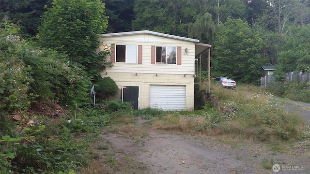 17711 Viking Way NW, Poulsbo, WA 98370 - view of front of property featuring driveway, a wooded view, and an attached garage