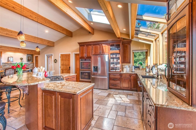 1669 Day Lake Rd, Orcas Island, WA 98245 - kitchen featuring stainless steel appliances, a skylight, stone tile flooring, recessed lighting, and glass insert cabinets