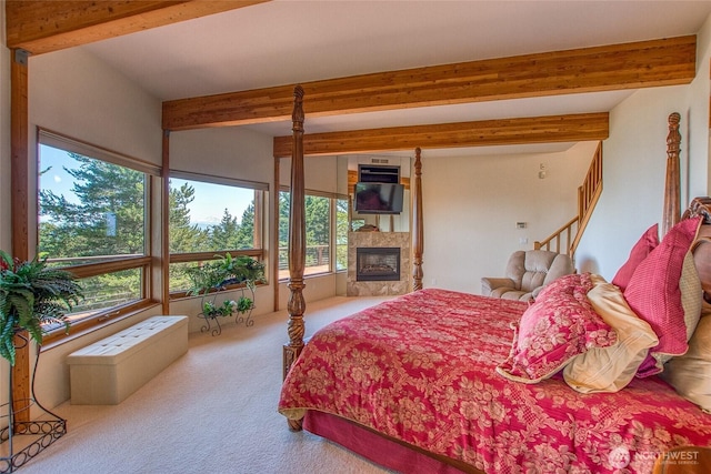 1669 Day Lake Rd, Orcas Island, WA 98245 - bedroom with beam ceiling, carpet flooring, and a glass covered fireplace