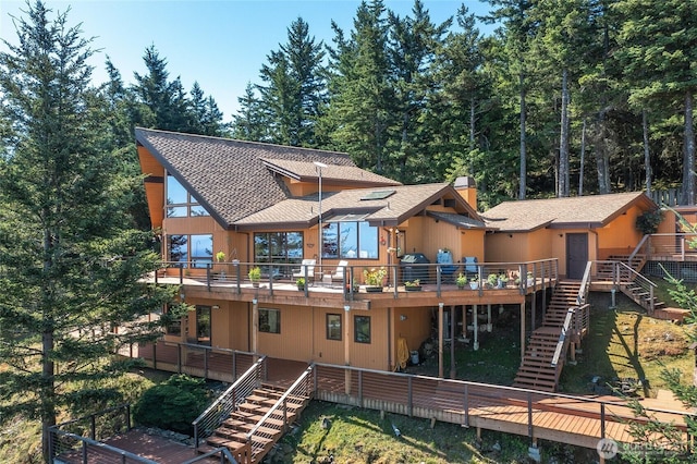 1669 Day Lake Rd, Orcas Island, WA 98245 - rear view of property featuring stairway, a deck, roof with shingles, and a chimney