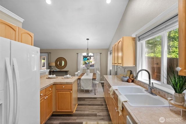 490 E Mountain View Dr, Allyn, WA 98524 - kitchen with white refrigerator with ice dispenser, lofted ceiling, dark wood-style floors, a chandelier, and decorative light fixtures