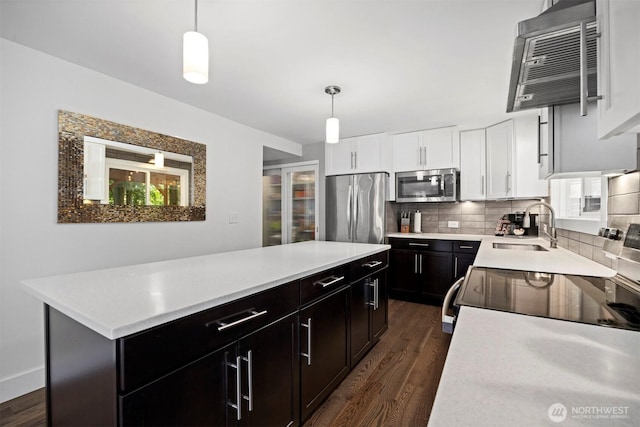 13 Westbrook Ct, Bellingham, WA 98229 - kitchen with stainless steel appliances, a kitchen island, dark wood-type flooring, light countertops, and tasteful backsplash