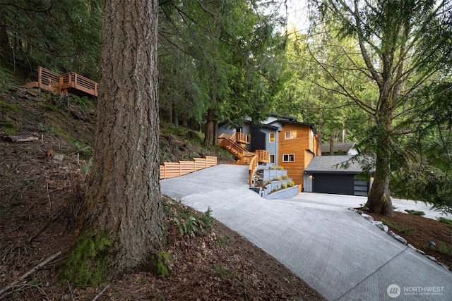 13 Westbrook Ct, Bellingham, WA 98229 - view of yard featuring stairs, driveway, a garage, and a forest view