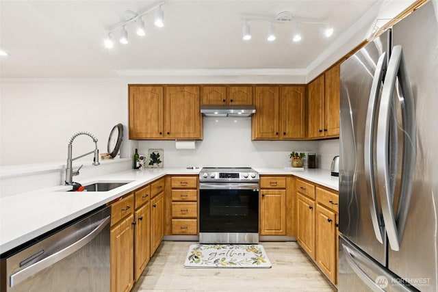 13216 NE 138th Pl, Kirkland, WA 98034 - kitchen featuring appliances with stainless steel finishes, under cabinet range hood, crown molding, light countertops, and rail lighting