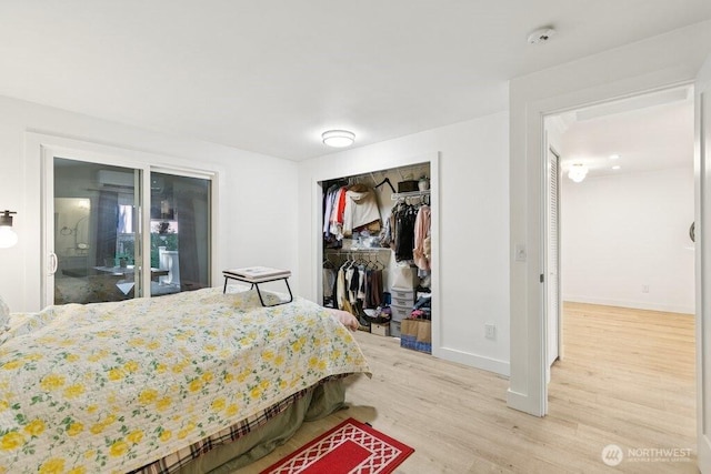 13216 NE 138th Pl, Kirkland, WA 98034 - bedroom featuring wood finished floors, a closet, and an AC wall unit
