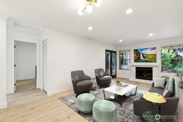 13216 NE 138th Pl, Kirkland, WA 98034 - living area with ornamental molding, recessed lighting, light wood finished floors, and a premium fireplace