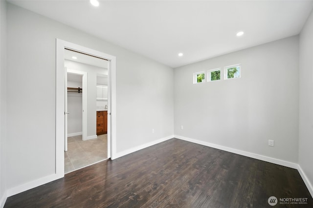 461 NE Lambert Ave, College Place, WA 99324 - unfurnished bedroom with recessed lighting, dark wood finished floors, a walk in closet, and a closet
