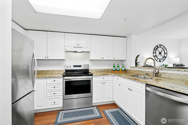 23335 Cedar Way Unit B204, Mountlake Terrace, WA 98043 - kitchen featuring appliances with stainless steel finishes, under cabinet range hood, dark wood-type flooring, and white cabinetry