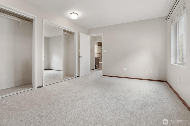 1156 Alki Ave SW Unit 202, Seattle, WA 98116 - unfurnished bedroom with carpet flooring and two closets