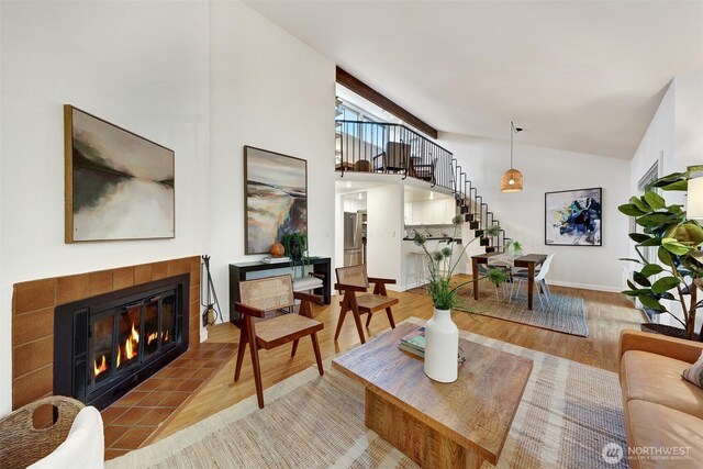 8941 Ravenna Ave NE, Seattle, WA 98115 - living room with wood finished floors, stairs, a tile fireplace, and high vaulted ceiling
