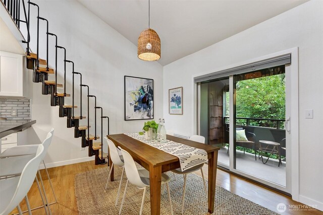 8941 Ravenna Ave NE, Seattle, WA 98115 - dining space with stairway, light wood-style flooring, and high vaulted ceiling