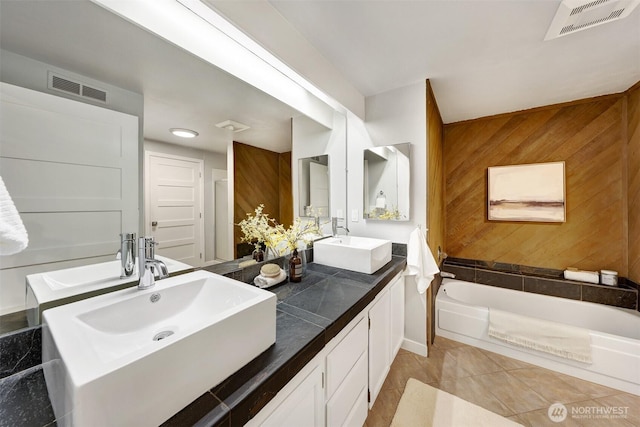 8941 Ravenna Ave NE, Seattle, WA 98115 - full bathroom with double vanity, a garden tub, wood walls, and tile patterned flooring