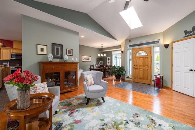 3205 Shelly Hill Rd, Mount Vernon, WA 98274 - entrance foyer featuring lofted ceiling, wood finished floors, a ceiling fan, a skylight, and a chandelier