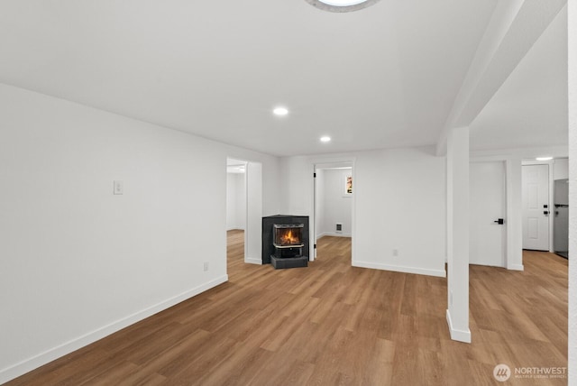 608 NE 2nd St, Winlock, WA 98596 - finished below grade area with recessed lighting, light wood finished floors, and freestanding refrigerator