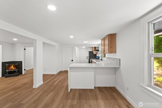 608 NE 2nd St, Winlock, WA 98596 - kitchen featuring healthy amount of natural light, light wood-style floors, recessed lighting, and a glass covered fireplace