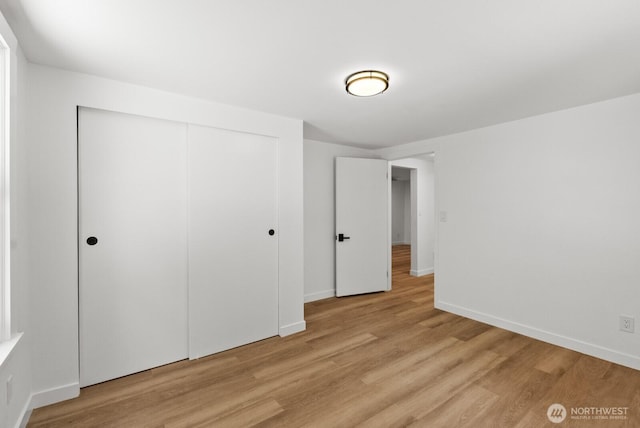 608 NE 2nd St, Winlock, WA 98596 - unfurnished bedroom featuring light wood-style flooring and a closet