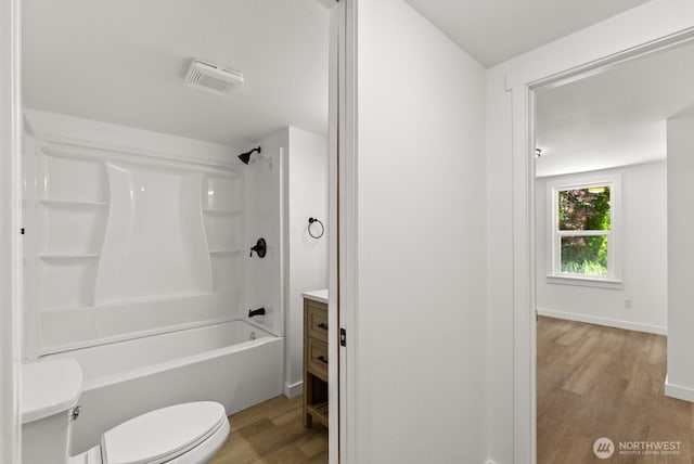 608 NE 2nd St, Winlock, WA 98596 - bathroom with wood finished floors, vanity, and shower / washtub combination