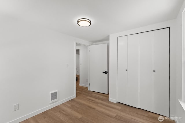 608 NE 2nd St, Winlock, WA 98596 - unfurnished bedroom with light wood-type flooring and a closet