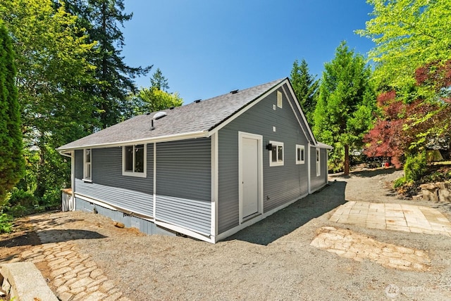 608 NE 2nd St, Winlock, WA 98596 - view of side of home with crawl space, a shingled roof, and a patio